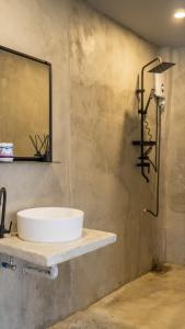 a bathroom with a sink and a mirror on the wall at Villa Rosa Siargao in General Luna +32 photos