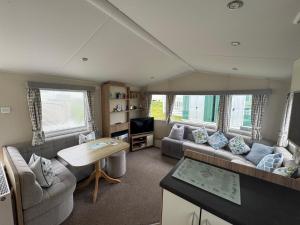 a living room with a couch and a table at Newquay Bay Resort getaway in Porth