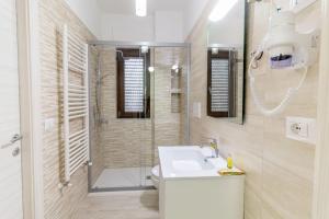a bathroom with a toilet and a sink and a shower at Al Solito Posto Affittacamere in Alianello