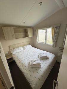 a bedroom with a bed with two towels on it at Newquay Bay Resort getaway in Porth +10 photos