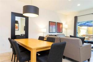 a dining room and living room with a table and chairs at 3065 YL - Cozy 2BR Townhome - Encantada in Kissimmee