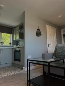 a living room with a couch and a table at Two bed flat in Cardiff in Cardiff