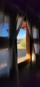 a room with a window with a view of a field at Serena Cumbre Lodge in San Rafael +11 photos