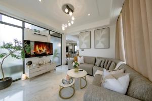 a living room with a couch and a tv at The AntBox Kingsland City Ibexhill in Lusaka