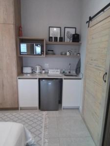 a small kitchen with a sink and a refrigerator at Golfers Haven Studio Apartment in Langebaan