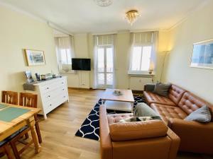 a living room with a couch and a table at Ostseeliebe, direkt an der Promenade in Warnemünde