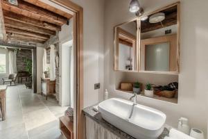 a bathroom with a sink and a mirror at Ama'Ca Dulza - by MyHomeInComo in Laglio +30 photos