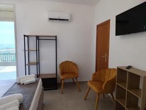 a living room with two chairs and a television at La Tartana in Castro di Lecce