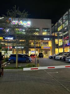 a parking lot with cars parked in front of a building at Cozy 1BR Hideout Kilimani in Nairobi