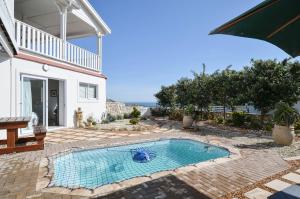 a swimming pool in the backyard of a house at Hemelstoep Pool View in Yzerfontein