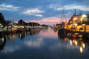 a group of boats docked in a marina at night at Appartement Schwalbenflug in Warnemünde +5 photos