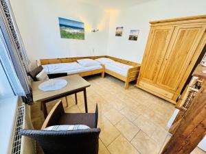 a living room with a couch and a table at Appartement Feuerdorn in Warnemünde +5 photos