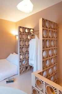 a bedroom with a mirror next to a bed at Via Vasileia in Kattavía