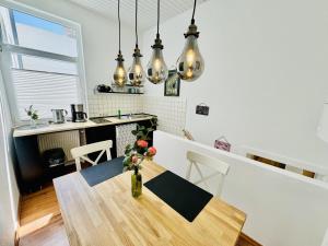 a kitchen with a table with a vase of flowers at Appartement Rosenwinkel in Warnemünde