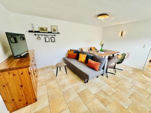 a living room with a couch and a table at Appartement Sonnenflut in Warnemünde
