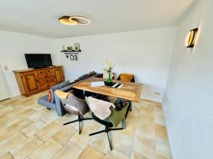 a living room with a table and a couch at Appartement Sonnenflut in Warnemünde