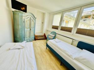 a room with two beds and a chair in it at Appartement Sonnenflut in Warnemünde