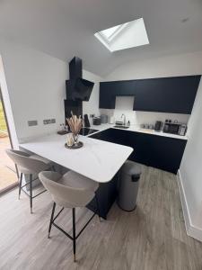 a kitchen with a white table and chairs at Portbridge Nest in Chew Magna