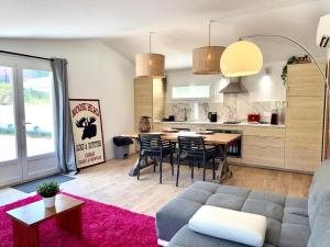 a living room with a couch and a table at Nature house, pool, quiet in Contes