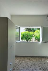 an empty room with a large window and a white wall at Casa vacanza da Flavia in Acquarica del Capo +14 photos