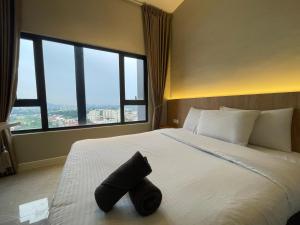 a bedroom with a white bed with a large window at Imperio Private Bathtub Melaka Town By MICASA GROUP in Melaka +106 photos