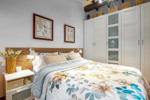 a bedroom with a bed and white cabinets at Casa Trinidad in Denia