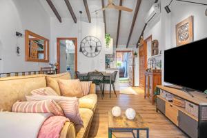 a living room with a couch and a flat screen tv at Casa Trinidad in Denia