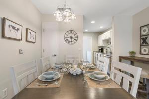 a kitchen and dining room with a table and chairs at Hillside Cottage in The Vineyards Resort in Branson