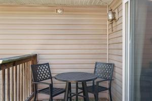 two chairs and a table on a porch at Hillside Cottage in The Vineyards Resort in Branson
