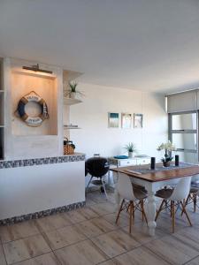 a kitchen with a table and chairs in a room at Vista Bonita 29 in Mossel Bay