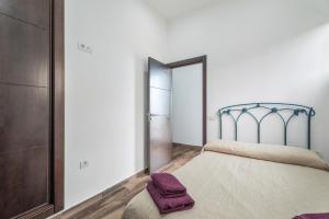 a bedroom with a bed with a purple blanket at Casa Rural Tijoco in Adeje +15 photos