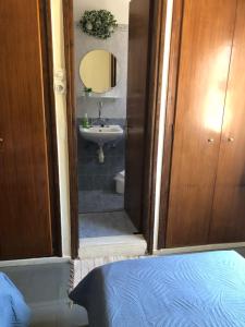 A bed or beds in a room at Platanos Rooms