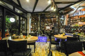 a restaurant with two tables and chairs in a room at Grand Apartments Scepanovic in Tivat