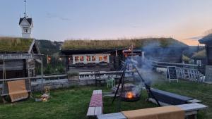 a fire pit in a yard next to a building at Cozy Apartment by the slopes in Kvitfjell Vest in Favang