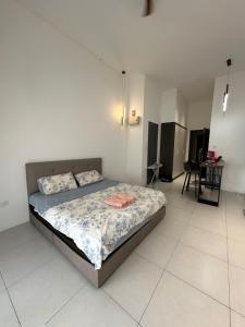 a bedroom with a bed in a white room at The Podium opp Aeon Mall Kuching in Kuching
