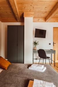 a bedroom with a bed with a chair and a desk at Sumi Potok Siedlisko in Nowe Bystre +123 photos