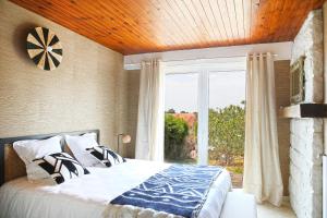 a bedroom with a bed and a large window at Villa Saint-Martin in Jullouville-les-Pins