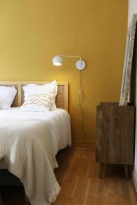 a bedroom with a white bed and a lamp at Villa Saint-Martin in Jullouville-les-Pins +33 photos