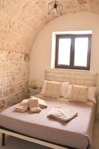 Postel nebo postele na pokoji v ubytování Il Trullo di Bina