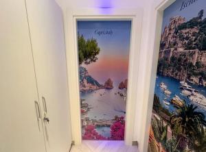 a room with a door with a picture of the ocean at Suite Eleven in Naples