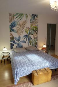 a bedroom with a bed with a suitcase at Villa hameau paisible Ardouane, à côté voie verte in Riols