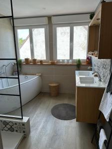 a bathroom with a tub and a sink at L œil de sangatte in Sangatte +15 photos