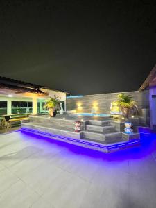 a house with a bunch of stairs with lights at Cobertura com Piscina, Sauna e Churrasqueira in São Pedro da Aldeia