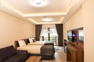 una camera d'albergo con un letto e un divano di Alnada Resort a Düzköy Altre 31 foto