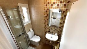 a bathroom with a toilet and a sink and a shower at Harmonia De La Mar in Altea +27 photos