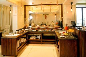 a kitchen with a counter with food on it at Hotel Amrta in Nagpur