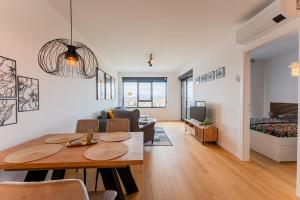 a living room with a table and a couch at Flex SelfCheckIns 142 - Zagreb - Bedroom - Garage - Loggia in Zagreb