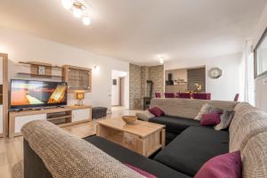 a living room with a couch and a tv at Holiday home Galižana in Galižana