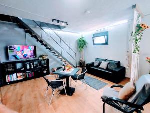 een woonkamer met een bank en een tafel bij Anglada, Villa with a private pool and jacuzzi in Lloret de Mar