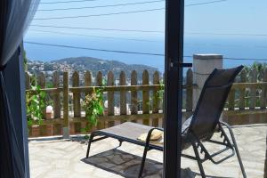 een stoel op een veranda met uitzicht bij Anglada, Villa with a private pool and jacuzzi in Lloret de Mar